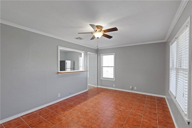 tiled spare room with ornamental molding, a textured ceiling, and ceiling fan