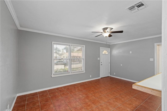 tiled foyer entrance featuring ornamental molding and ceiling fan