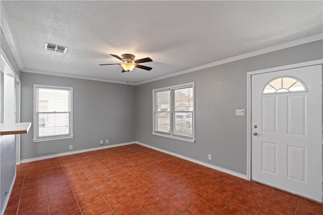 entrance foyer with ornamental molding, a textured ceiling, tile patterned floors, and ceiling fan