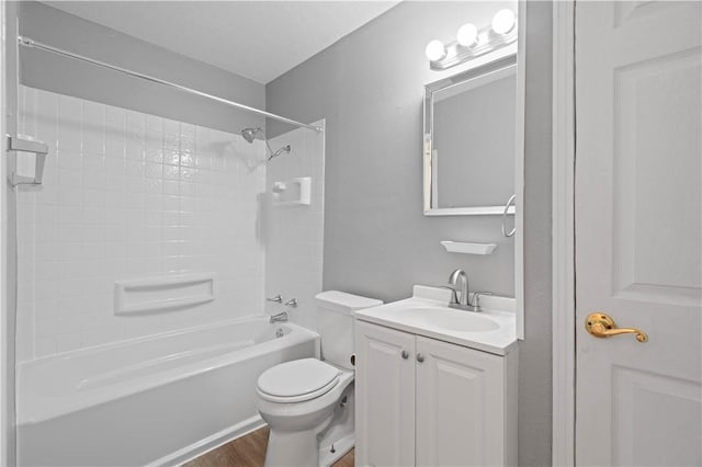 full bathroom with vanity, hardwood / wood-style floors, shower / tub combination, and toilet