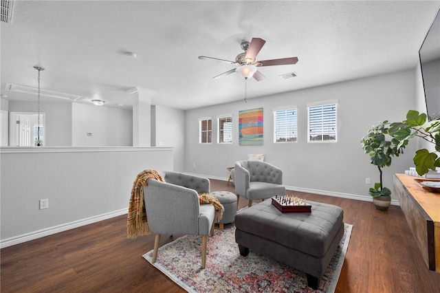 sitting room featuring visible vents, baseboards, ceiling fan, wood finished floors, and a textured ceiling