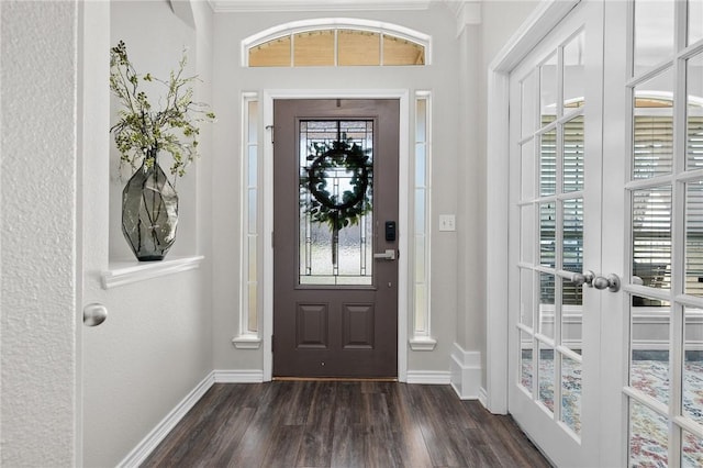 foyer featuring baseboards and dark wood-type flooring