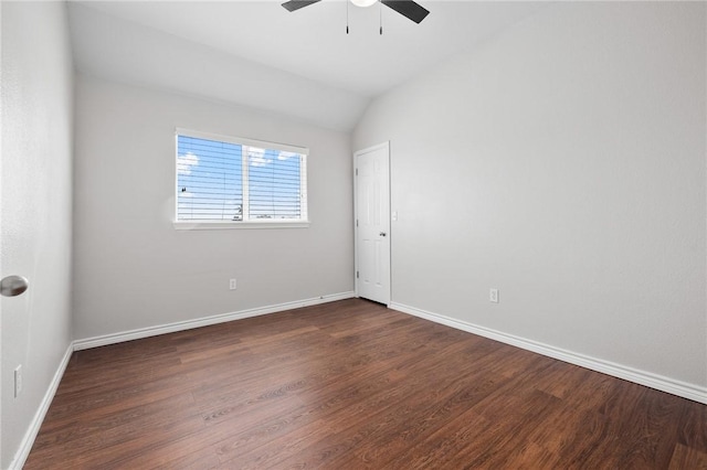 empty room with lofted ceiling, wood finished floors, a ceiling fan, and baseboards