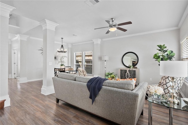 living room with dark wood-style flooring, visible vents, ornate columns, and ceiling fan with notable chandelier