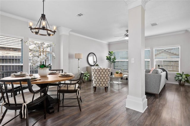 dining space with decorative columns, visible vents, dark wood finished floors, and crown molding