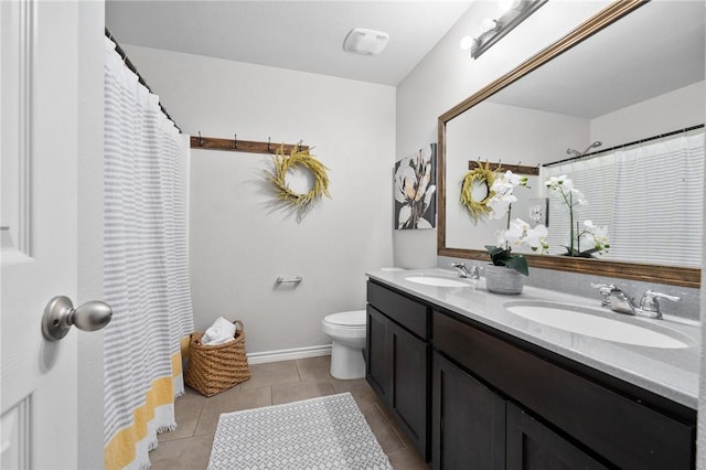 full bathroom featuring double vanity, tile patterned flooring, a sink, and toilet