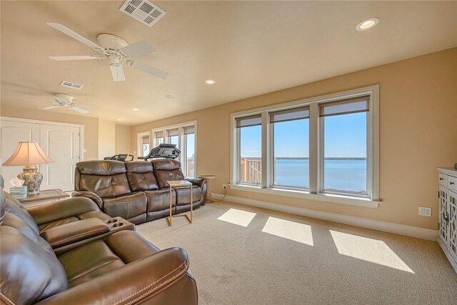 living area featuring recessed lighting, baseboards, visible vents, and light colored carpet