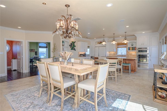 dining room with a healthy amount of sunlight, visible vents, and crown molding