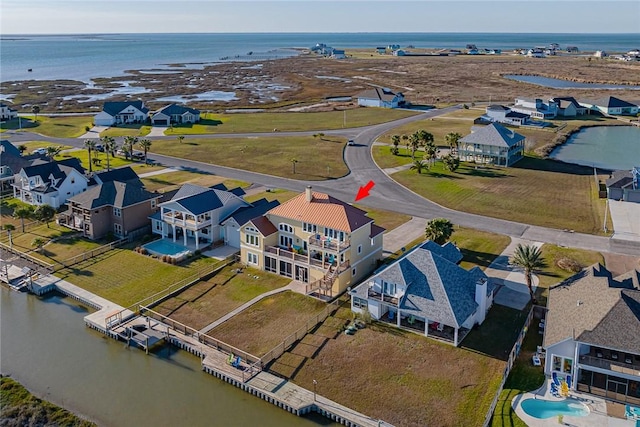 birds eye view of property with a water view and a residential view