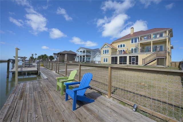 dock area with a water view and a residential view
