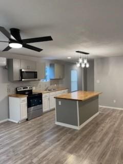 4414 Valdez Dr, Corpus Christi, TX 78416 - kitchen featuring appliances with stainless steel finishes, baseboards, wood finished floors, and a center island
