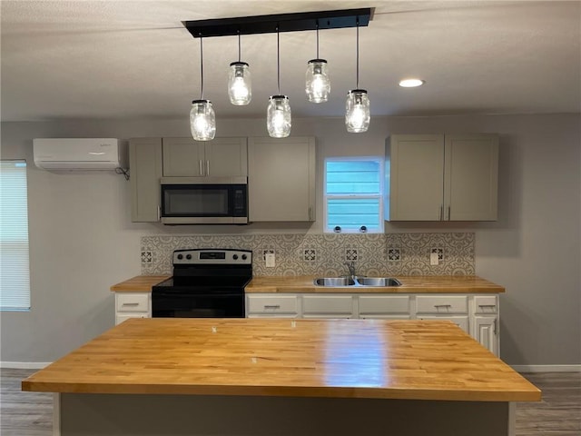4414 Valdez Dr, Corpus Christi, TX 78416 - kitchen with wooden counters, stainless steel microwave, range with electric stovetop, and a sink