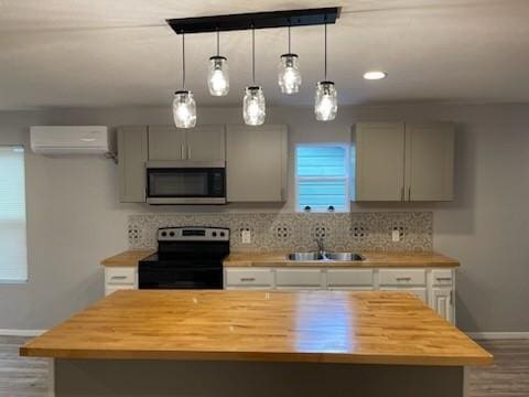 4414 Valdez Dr, Corpus Christi, TX 78416 - kitchen featuring stainless steel microwave, range with electric cooktop, butcher block counters, a sink, and a wall mounted AC