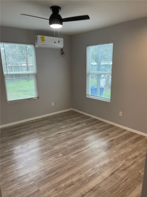 4414 Valdez Dr, Corpus Christi, TX 78416 - empty room with a wall unit AC, a ceiling fan, and wood finished floors