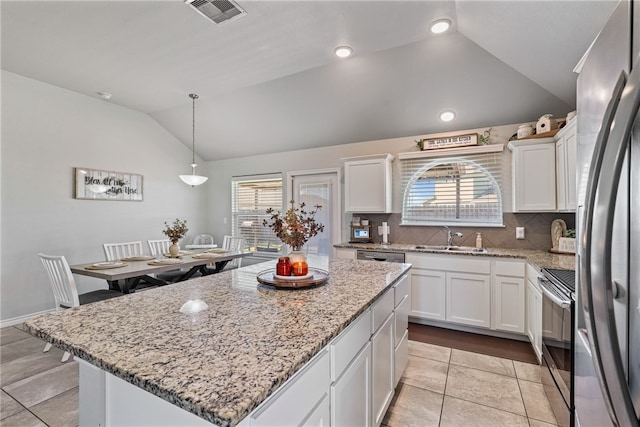 kitchen featuring white cabinetry, a center island, sink, stainless steel appliances, and pendant lighting