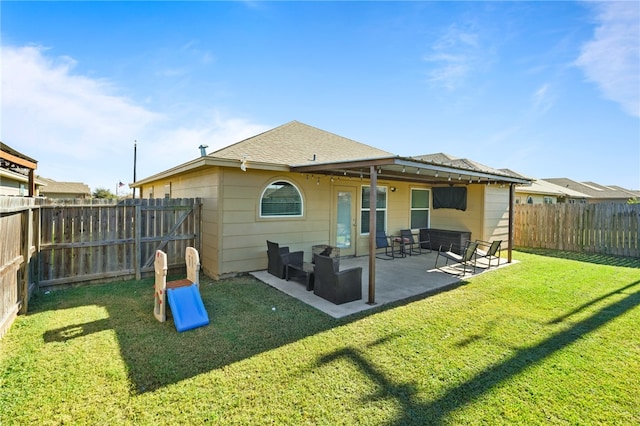 back of property featuring a lawn and a patio area