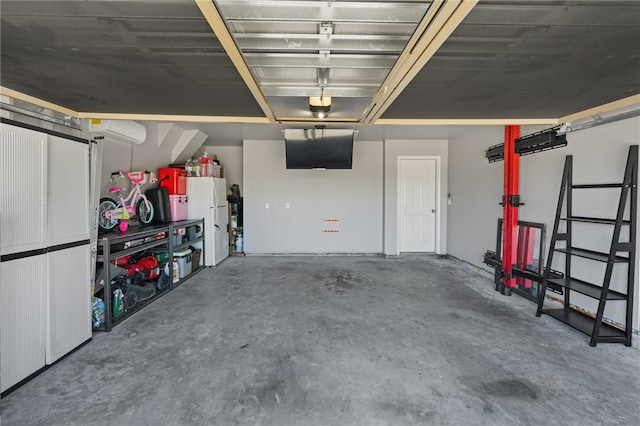 garage with white fridge and a wall mounted AC