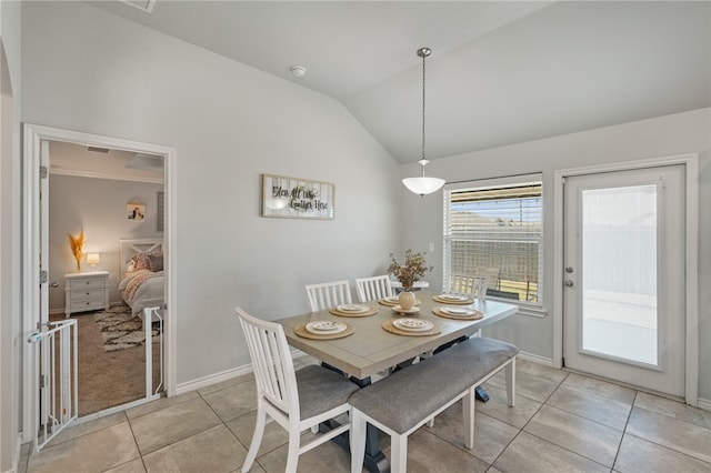 tiled dining room featuring lofted ceiling