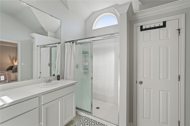 bathroom with vanity, crown molding, walk in shower, and lofted ceiling