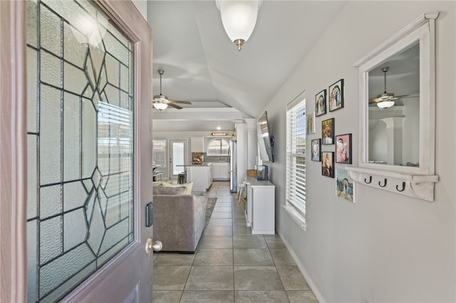 tiled foyer featuring ceiling fan and vaulted ceiling