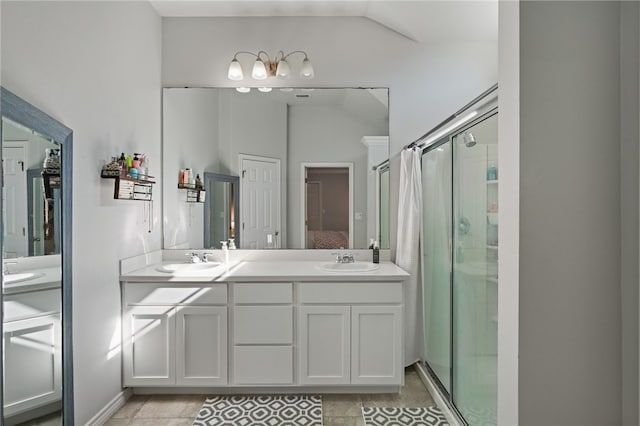 bathroom featuring tile patterned flooring, vanity, an enclosed shower, and lofted ceiling