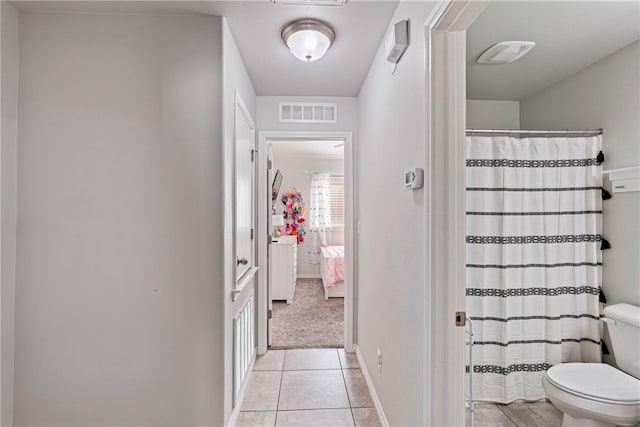 hall with light tile patterned flooring