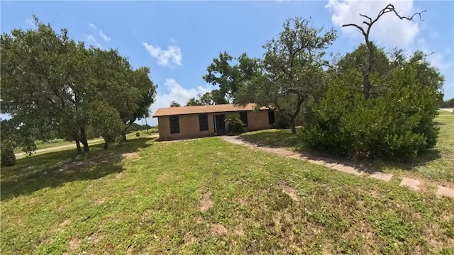 257 N 9th St, Aransas Pass, TX 78336 - back of house featuring a lawn