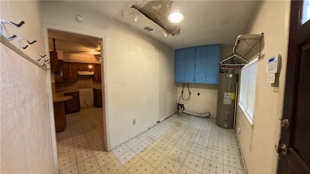 257 N 9th St, Aransas Pass, TX 78336 - laundry room featuring electric water heater and light floors