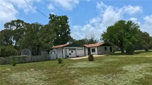257 N 9th St, Aransas Pass, TX 78336 - view of yard featuring an attached garage