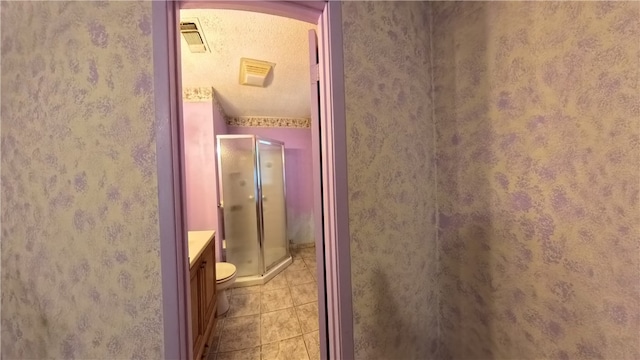 257 N 9th St, Aransas Pass, TX 78336 - bathroom with a shower stall, tile patterned flooring, and vanity