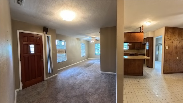 257 N 9th St, Aransas Pass, TX 78336 - entryway featuring a textured ceiling, a ceiling fan, and light carpet