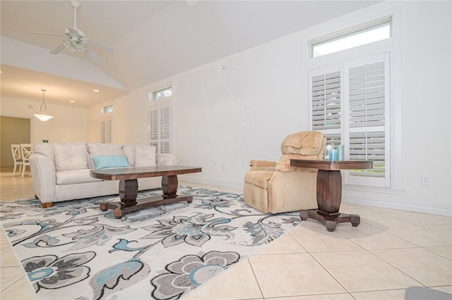 tiled living room with baseboards, ceiling fan, and lofted ceiling