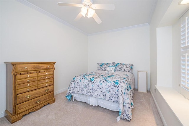 carpeted bedroom featuring baseboards, ornamental molding, a ceiling fan, and multiple windows