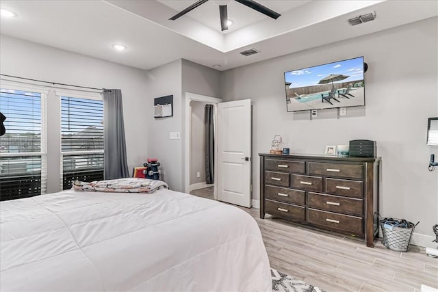 bedroom with baseboards, visible vents, and light wood-style flooring