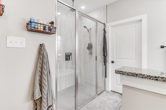 full bathroom featuring recessed lighting, wood finished floors, and a stall shower