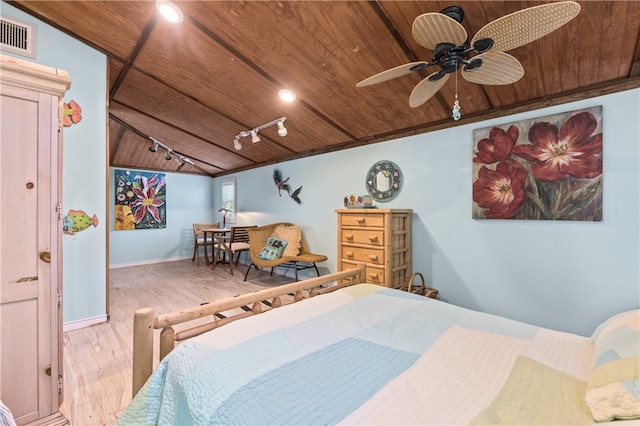 bedroom featuring lofted ceiling, wood ceiling, rail lighting, ceiling fan, and light hardwood / wood-style flooring