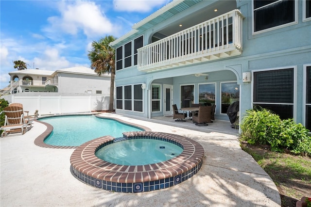 view of swimming pool with a patio area and an in ground hot tub