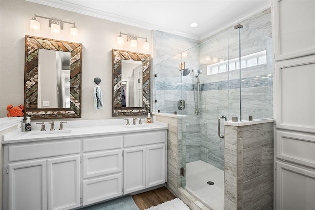 bathroom featuring ornamental molding, hardwood / wood-style floors, vanity, and a shower with door