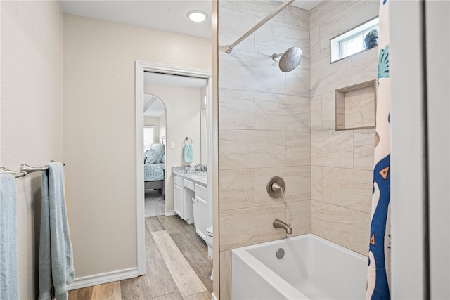 bathroom with vanity, shower / bath combination with curtain, and hardwood / wood-style floors