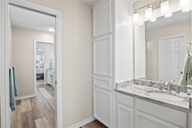 bathroom with vanity and hardwood / wood-style floors