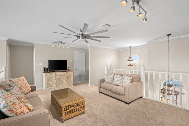 carpeted living room featuring ceiling fan with notable chandelier, crown molding, and rail lighting