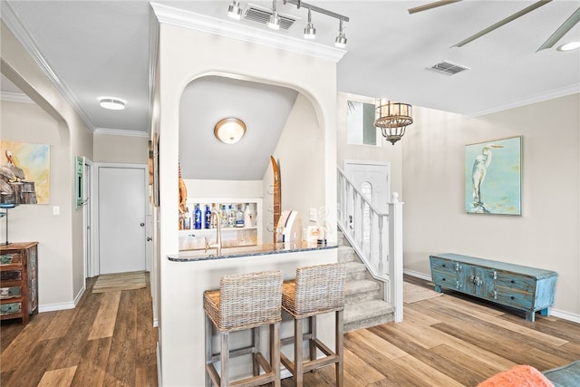 foyer entrance featuring hardwood / wood-style flooring, a chandelier, and ornamental molding