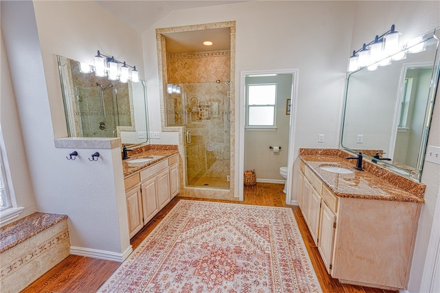 7710 Cisco, Corpus Christi, TX 78413 - bathroom with wood finished floors, a shower stall, and two vanities