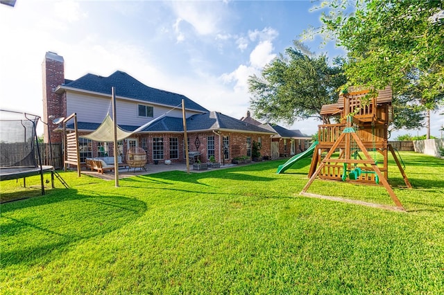 7710 Cisco, Corpus Christi, TX 78413 - rear view of house with a trampoline, a playground, a patio, brick siding, and a chimney