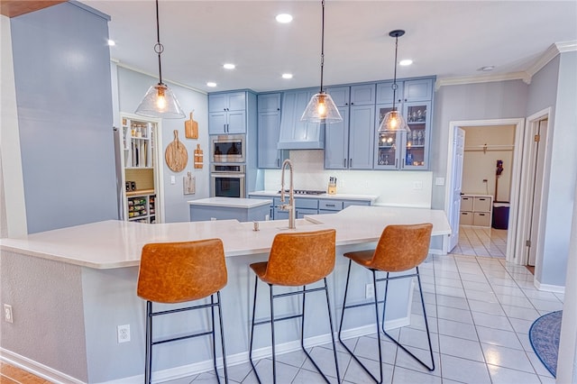 7710 Cisco, Corpus Christi, TX 78413 - kitchen featuring appliances with stainless steel finishes, tasteful backsplash, crown molding, a breakfast bar area, and recessed lighting