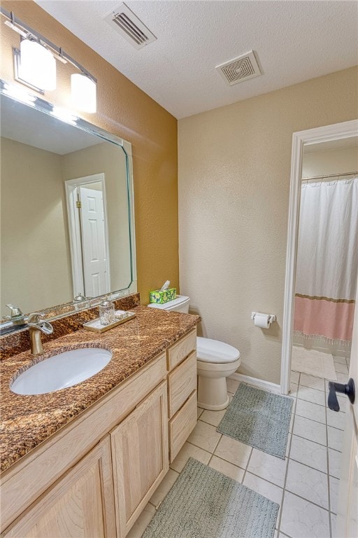 7710 Cisco, Corpus Christi, TX 78413 - bathroom featuring vanity, a textured ceiling, a textured wall, tile patterned floors, and a shower with shower curtain