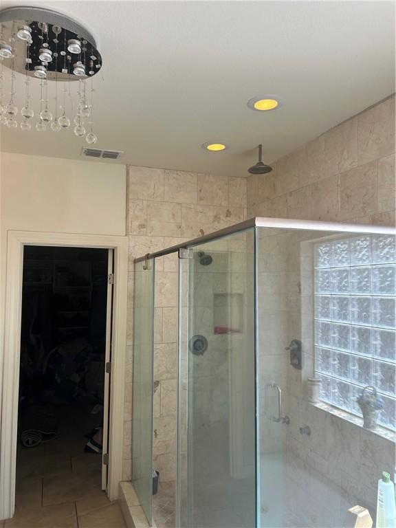 bathroom with tile patterned floors and an enclosed shower