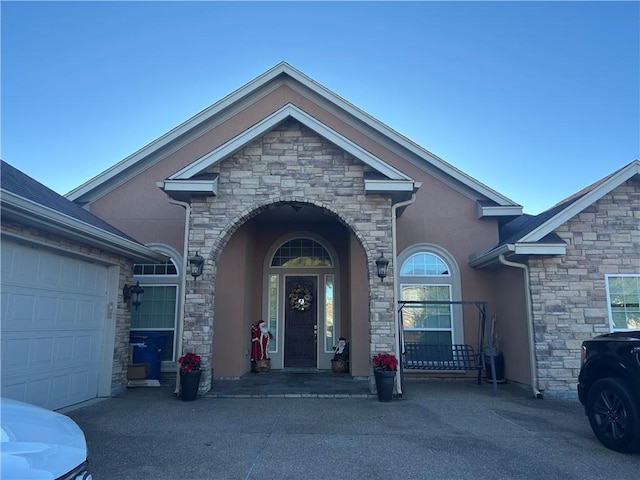 view of exterior entry with a garage