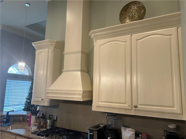 kitchen with white cabinets, backsplash, and light stone countertops