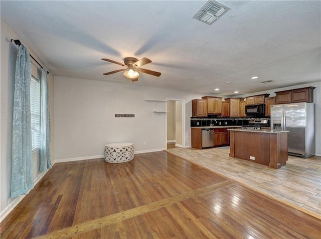1809 Merriman Ave, Corpus Christi, TX 78412 - kitchen with a center island, ceiling fan, light wood-style flooring, appliances with stainless steel finishes, and visible vents